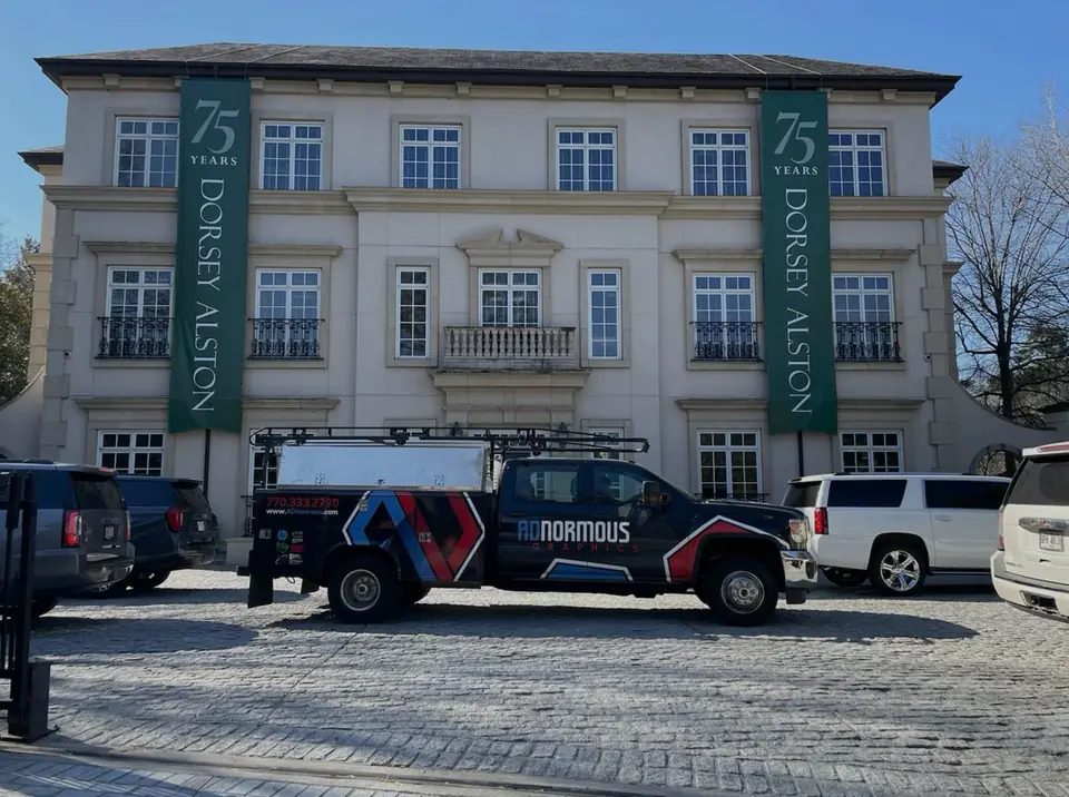 ADnormous Graphics wrapped fleet parked outside a client building